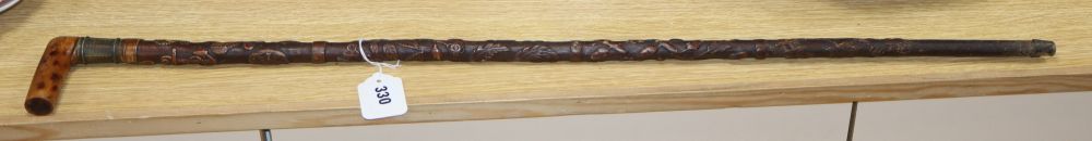 A Victorian walking stick, carved with a crown, an anchor and oak leaves, length 85cm